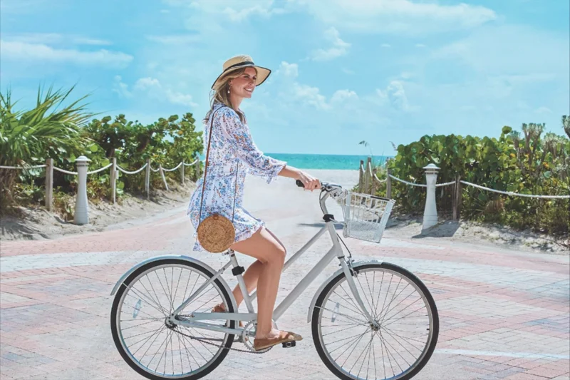 A person riding their bike near the beach.